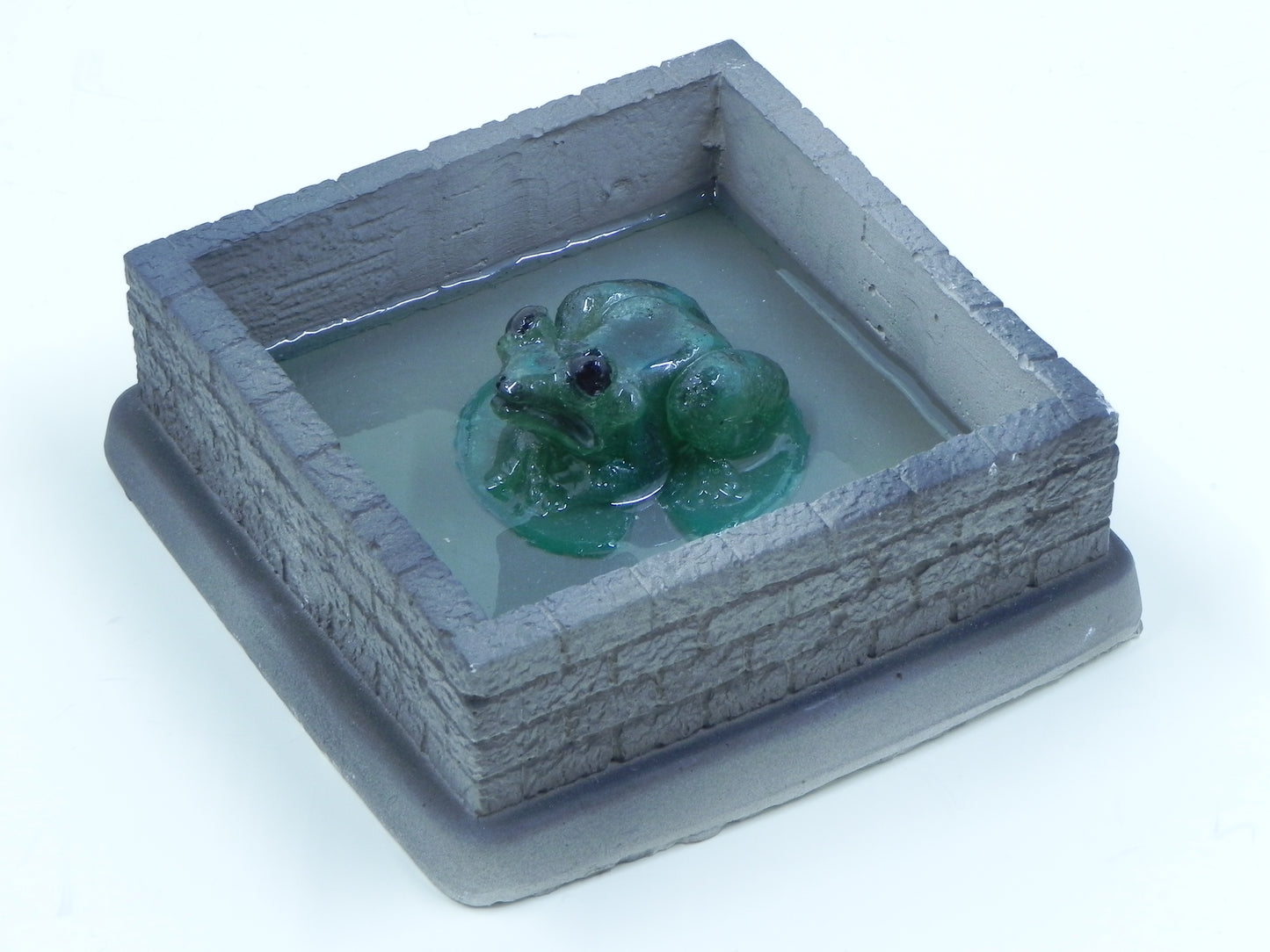 "Frog in stone walled pond"